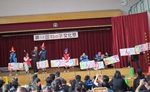舞台上でプラカードを掲げる児童生徒